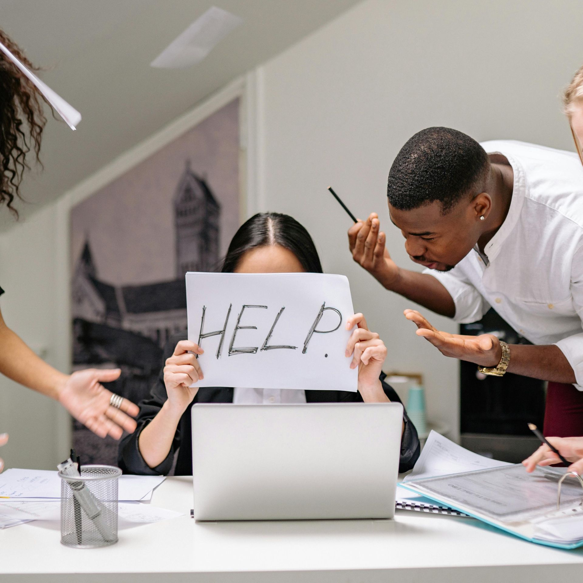 A group of frustrated employer's around a laptop