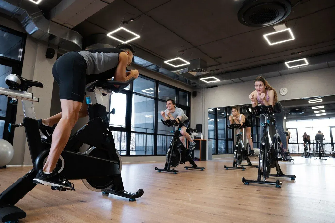 A group of people are riding exercise bikes in a gym in Los Angeles, CA