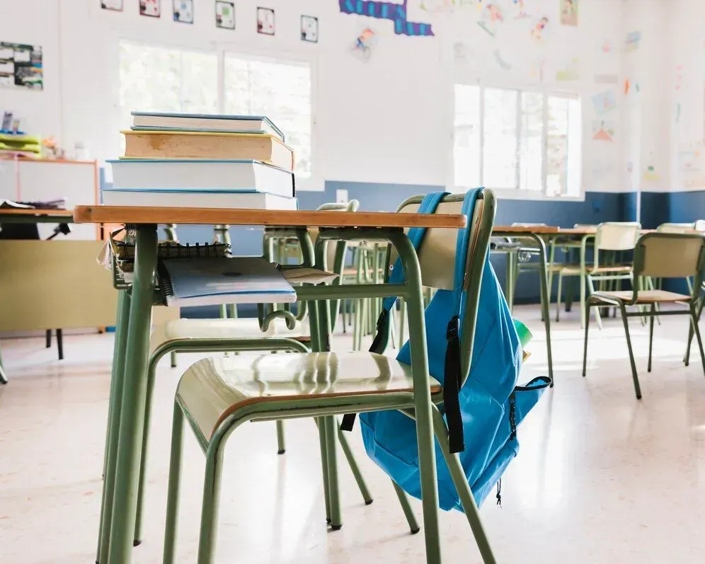 A blue backpack is sitting on a chair in a classroom in Los Angeles, CA