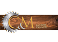 Logo for CM Custom Cabinets: Saw blade, gold lettering, and woodgrain background.