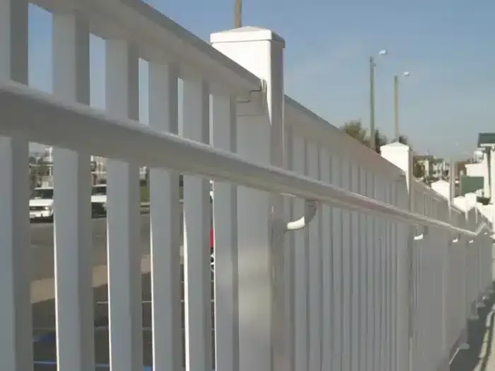 White handrail with curved return for accessibility on a porch.