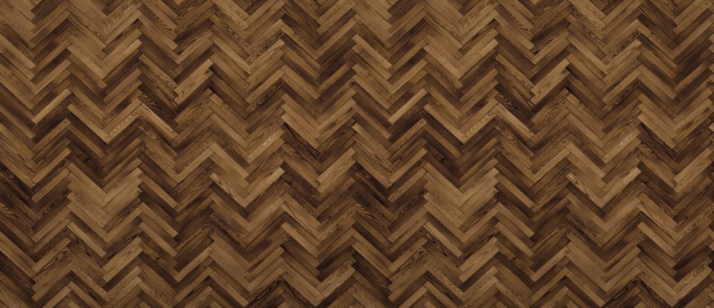 A Close Up of a Wooden Floor With a Herringbone Pattern — Marshall Notaras Hardwoods Pty Ltd In Armidale, NSW