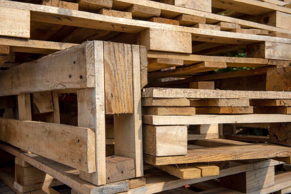 A Pile of Wooden Pallets Stacked on Top of Each Other — Marshall Notaras Hardwoods Pty Ltd In Tweed Heads, NSW