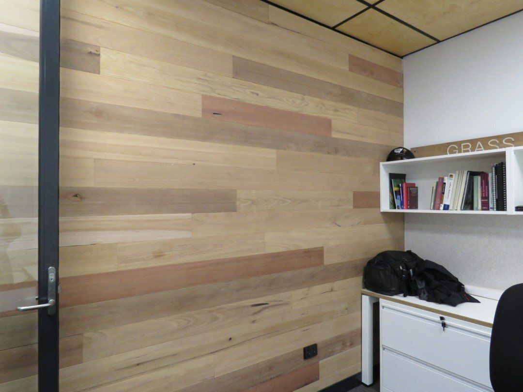 A Small Office With a Wooden Wall and a Desk — Marshall Notaras Hardwoods Pty Ltd In Lismore, NSW