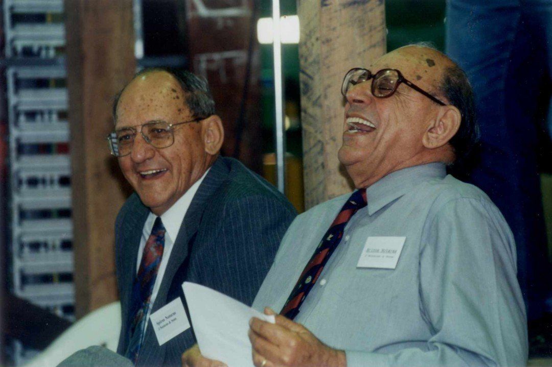 Two Men in Suits and Ties Are Laughing Together — Marshall Notaras Hardwoods Pty Ltd In Grafton, NSW