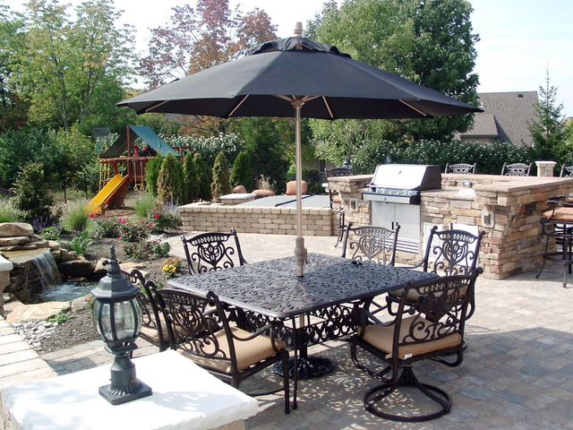 Table and umbrellas with outdoor kitchen