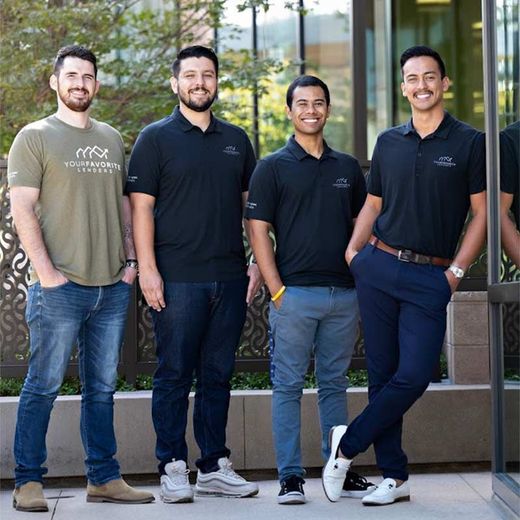 A group of men are posing for a picture and one of them is wearing a t-shirt that says nasa