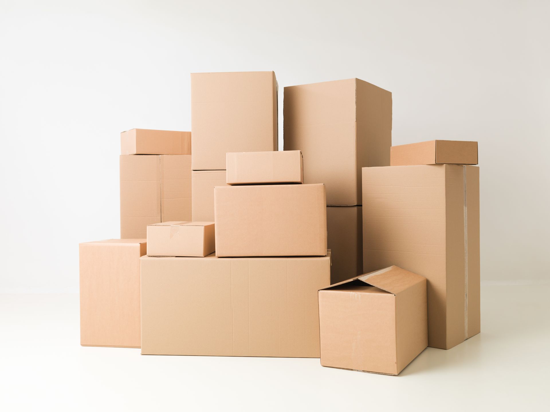 a pile of cardboard boxes stacked on top of each other on a white background .