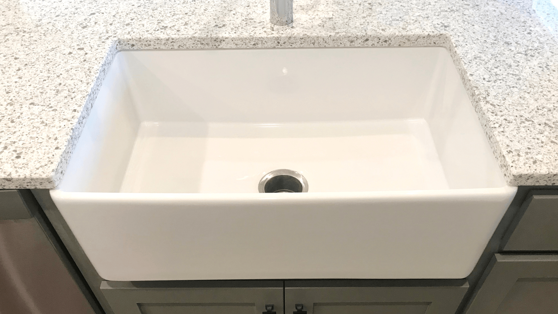 a kitchen sink with water running from the faucet .