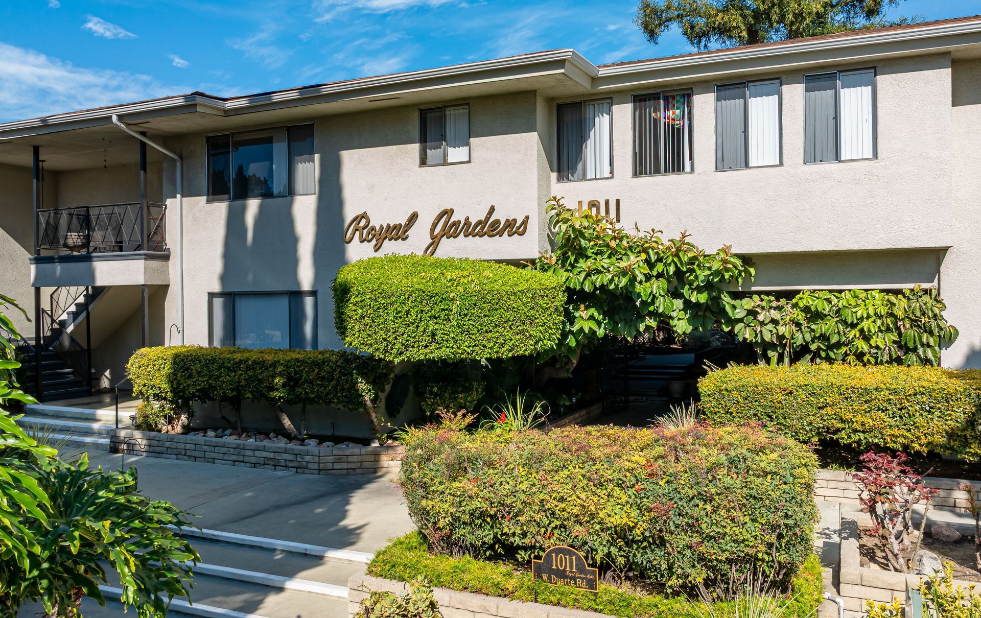 Two-story stucco apartment building named