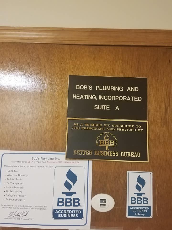 A door with a sign that says bob 's plumbing and heating incorporated