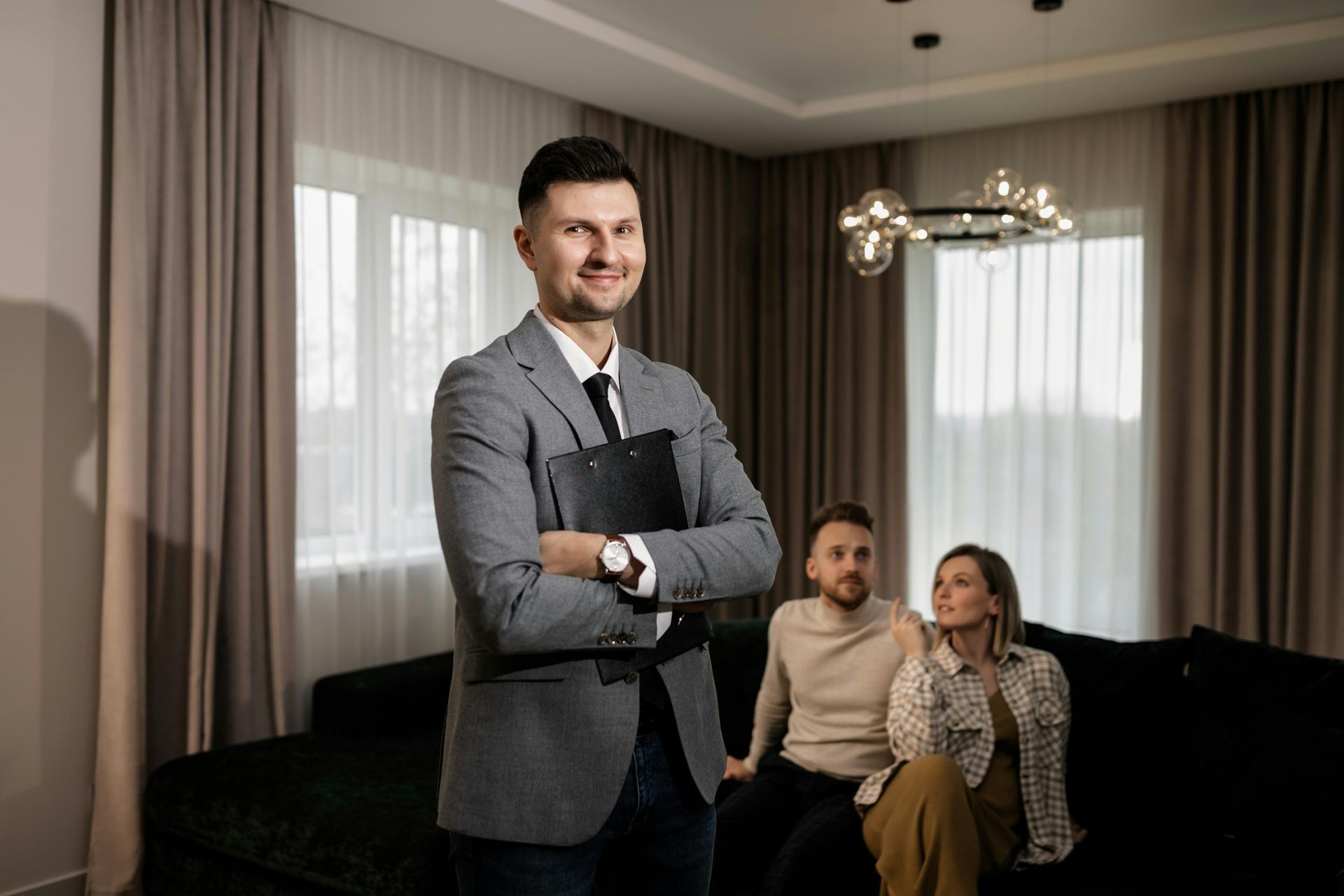 man holding a clipboard in a home talking to a woman about optivus claim solutions