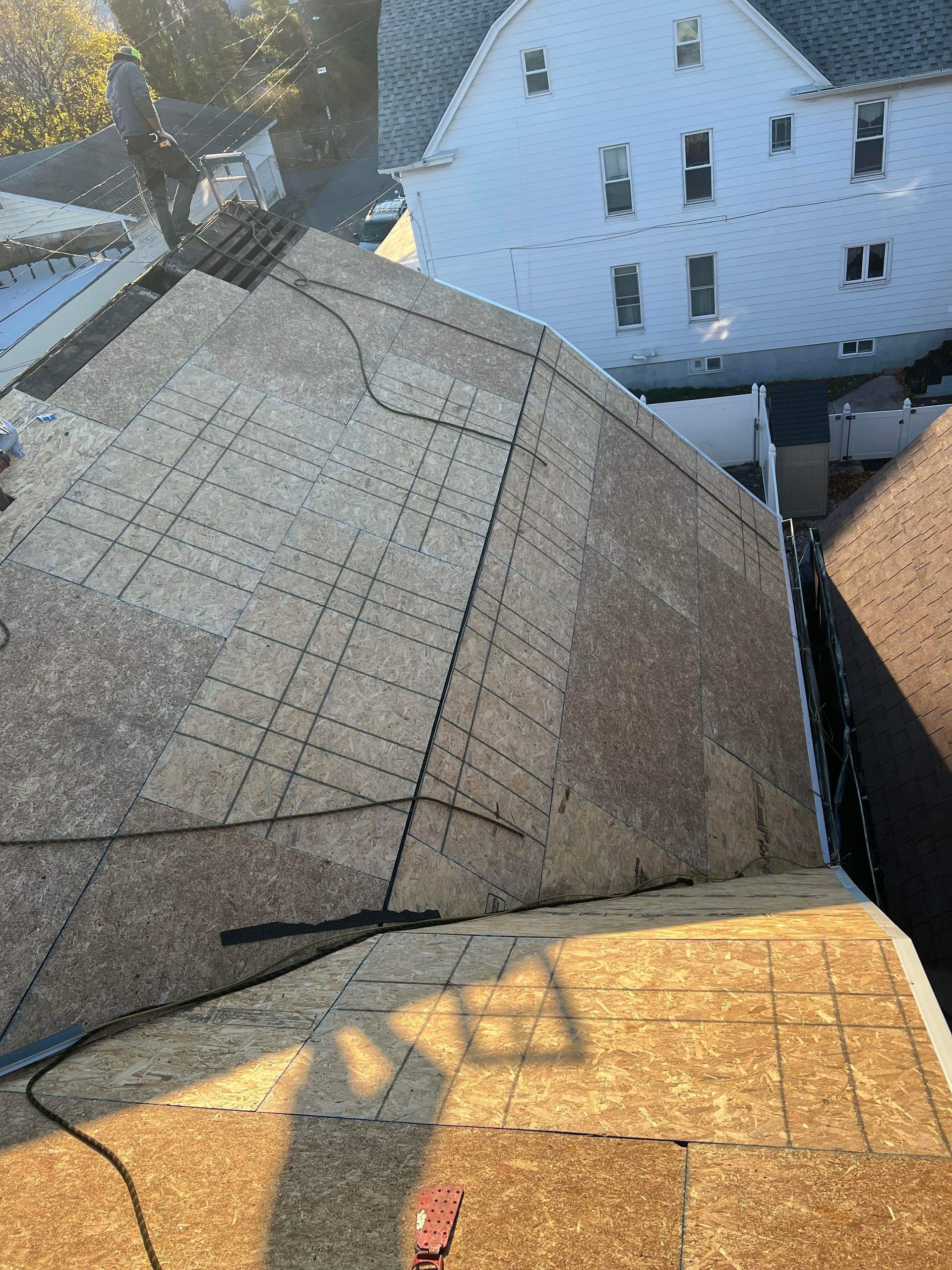 A person is working on a roof of a house