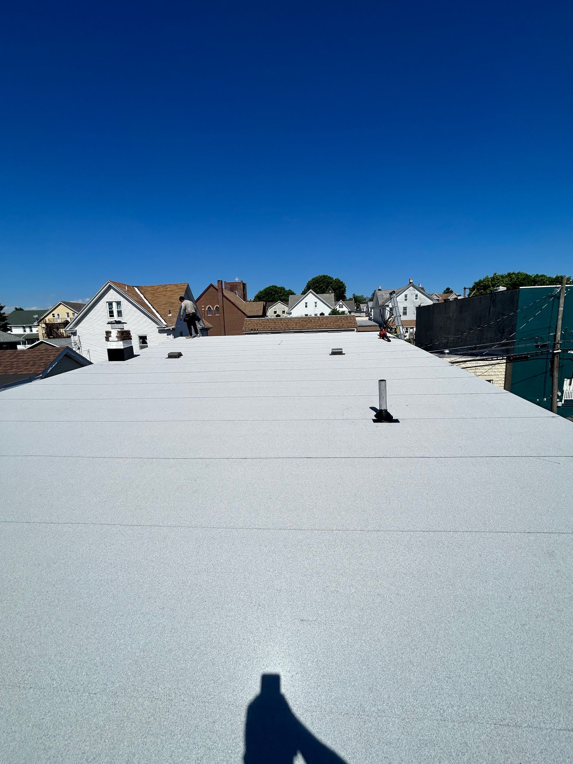 A white roof with a blue sky in the background