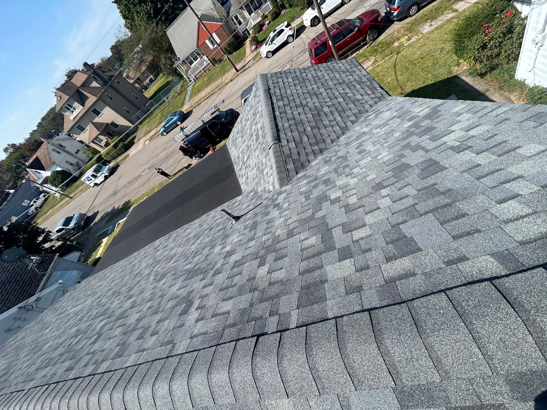 A roof with a lot of shingles on it in a residential area