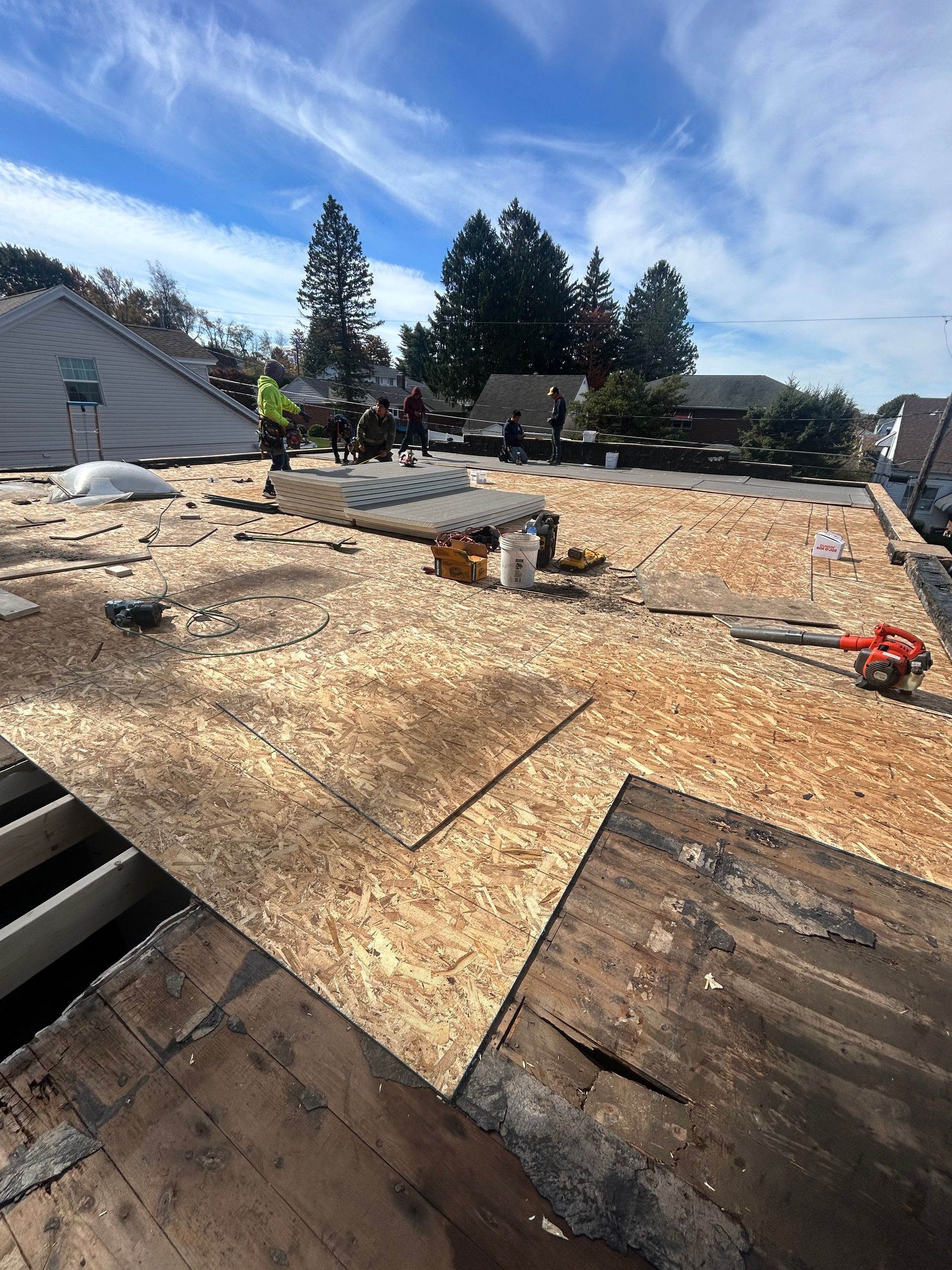 A roof is being repaired with a lot of plywood on it