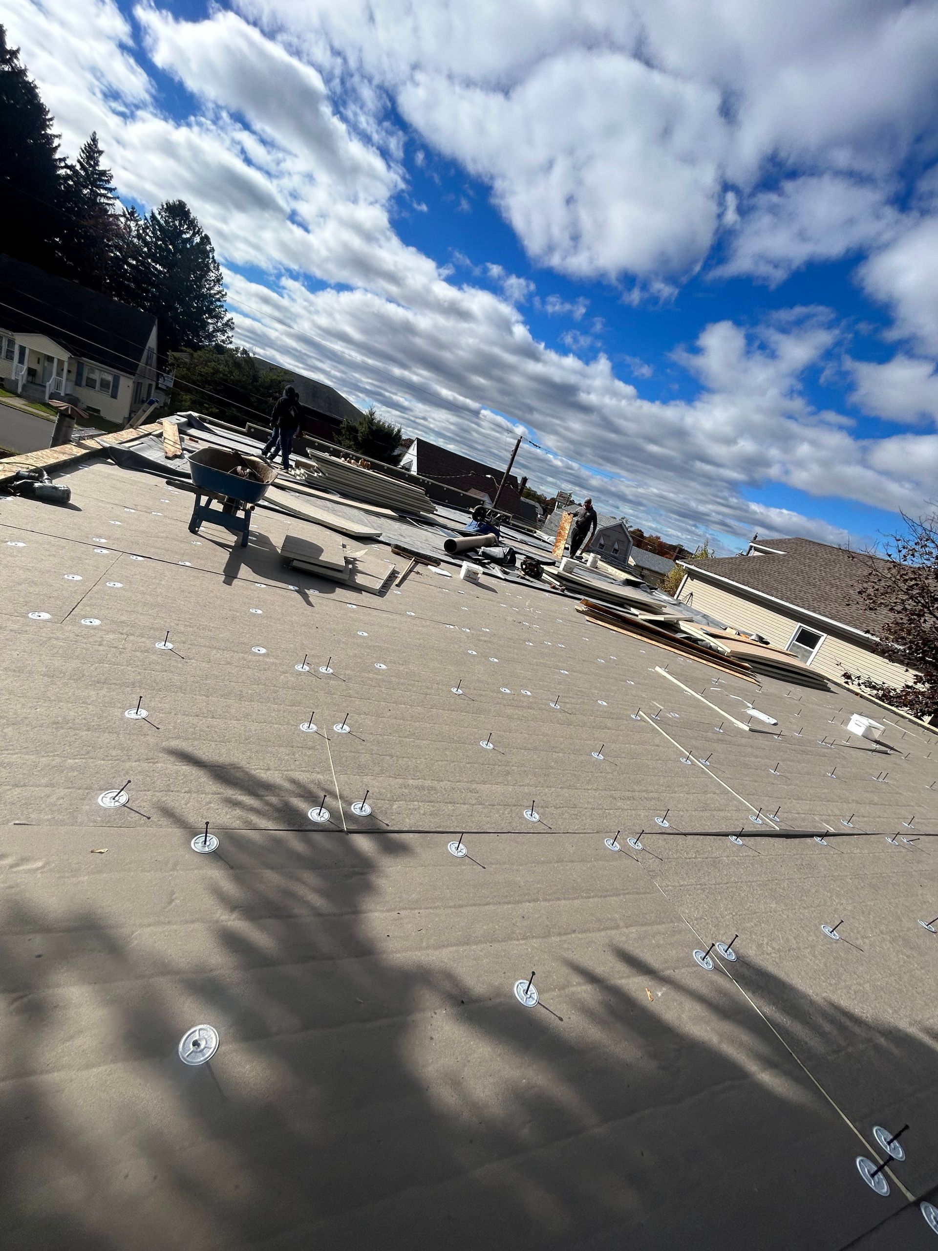 Flat roof with a lot of holes in it and a blue sky in the background.