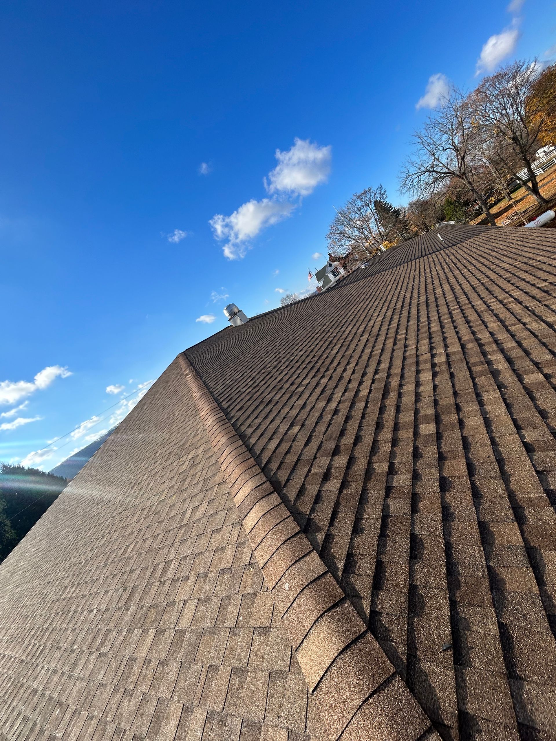 A close up of a roof with a blue sky in the background