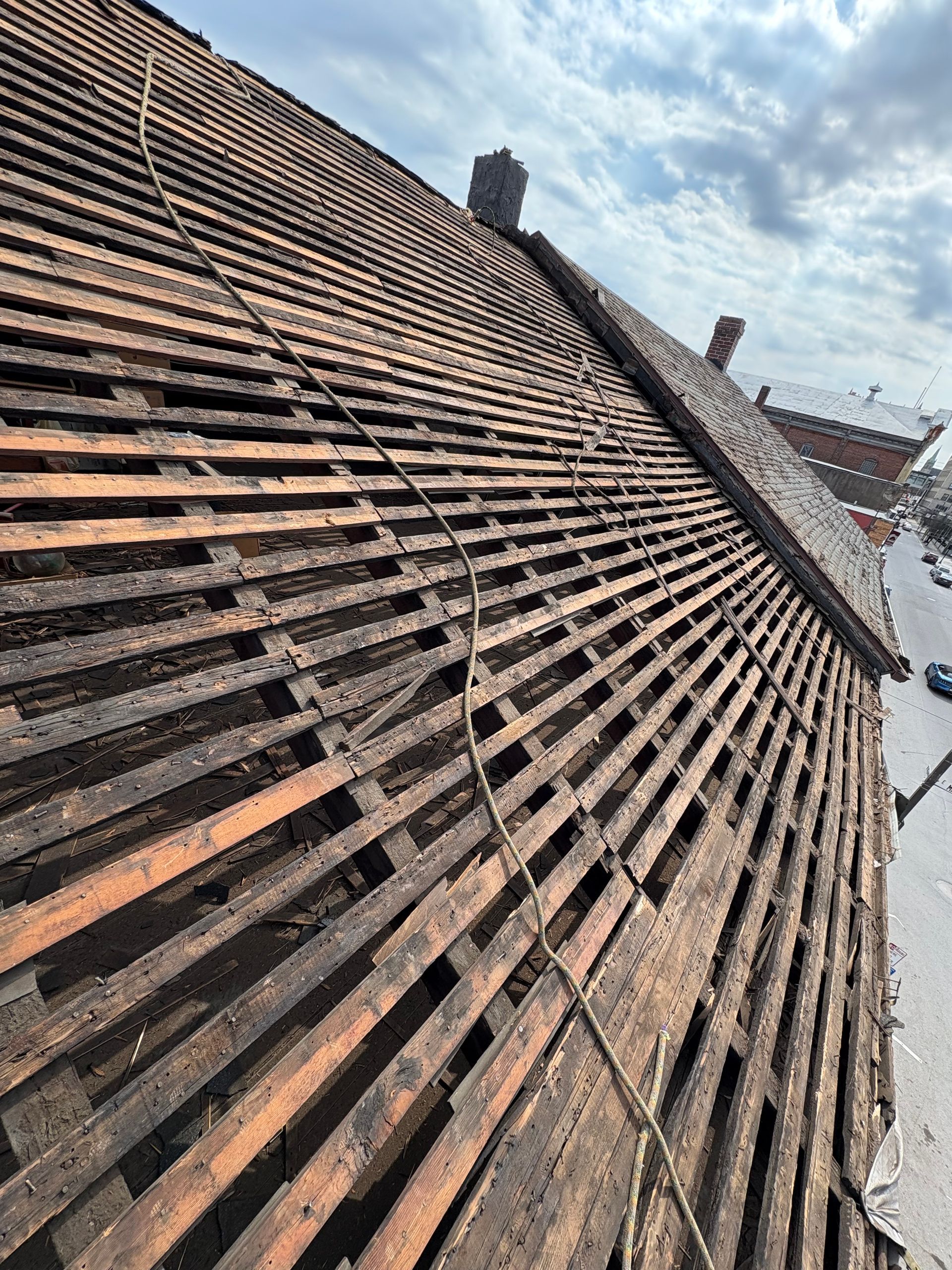 A close up of a wooden roof with a rope attached to it