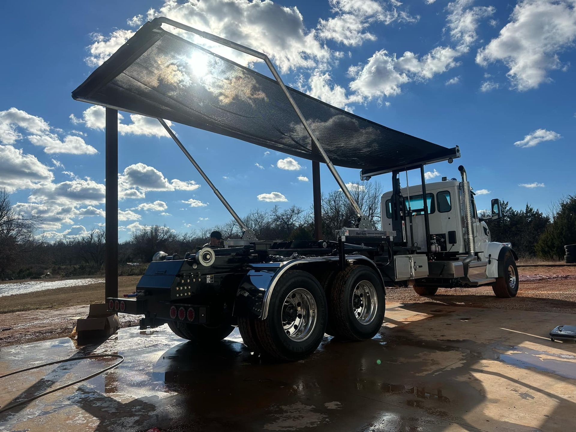 A dump truck with a canopy on top of it