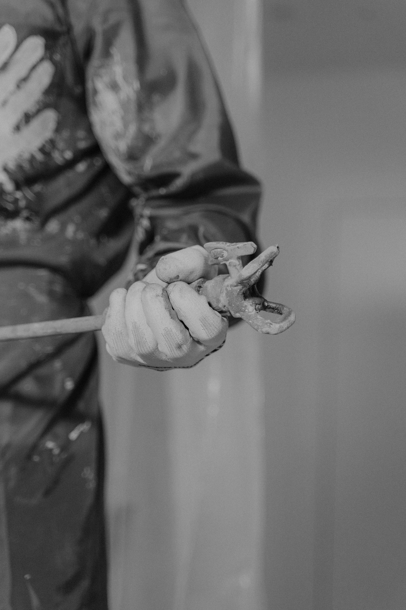 A black and white photo of a person holding a brush.