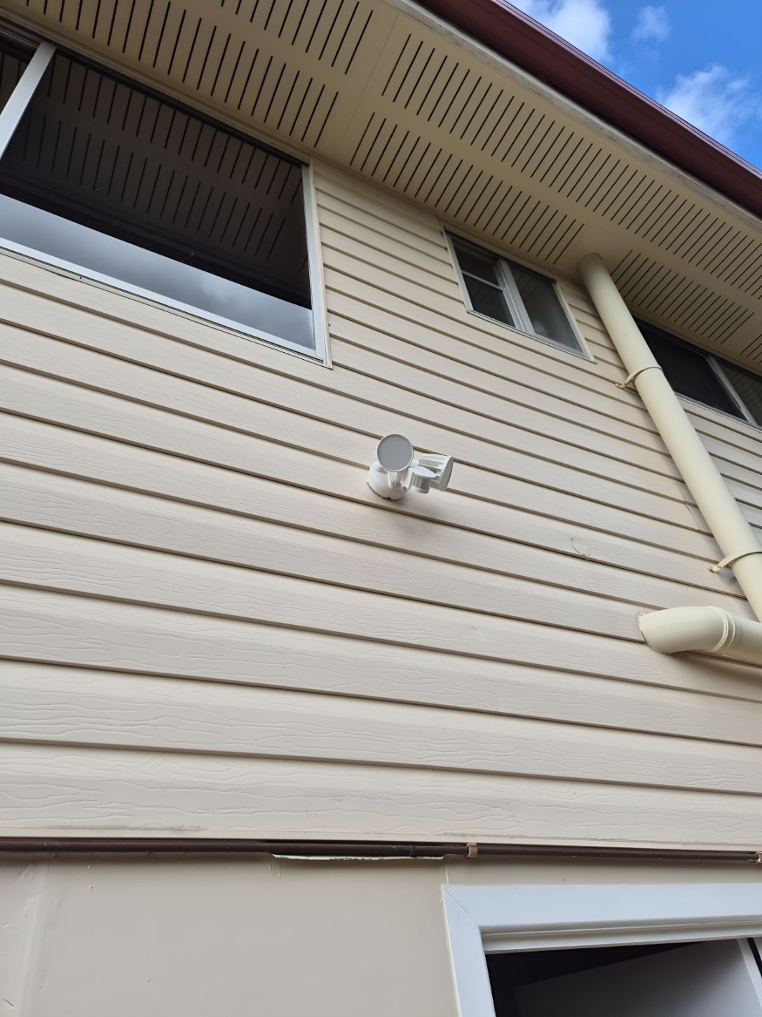 A House With a Lot of Windows and Siding on It — Our Sparky In Urraween, QLD