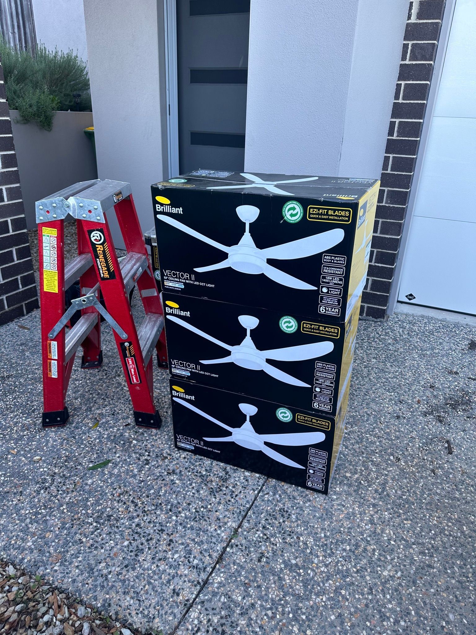 A ladder is sitting next to a box of ceiling fans. — Our Sparky In Urraween, QLD