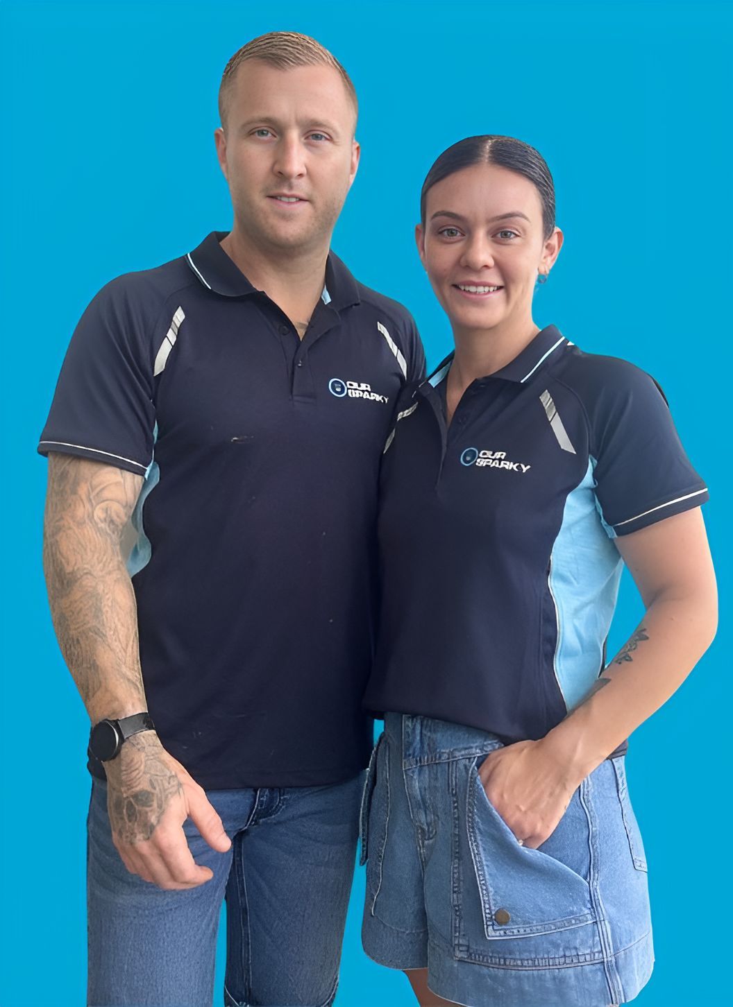A Man and a Woman Standing Next to Each Other Wearing Polo Shirts — Our Sparky In Urraween, QLD