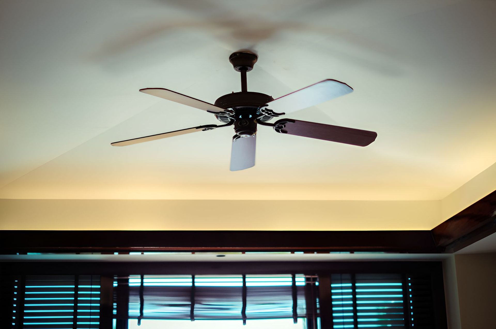 A Ceiling Fan is Hanging From the Ceiling of a Room — Our Sparky In Urraween, QLD
