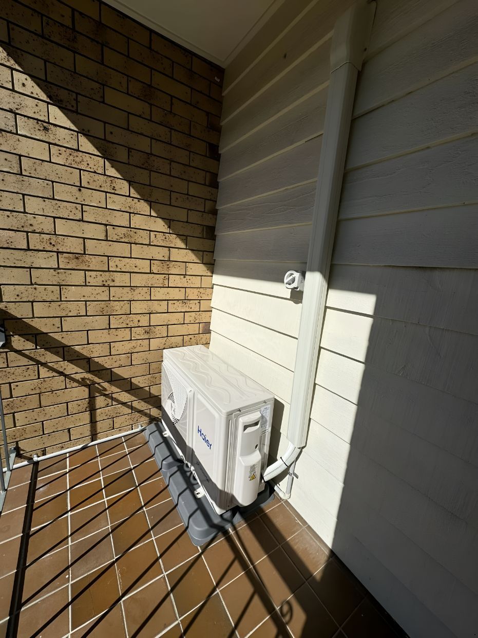 A White Box is Sitting on the Side of a Brick Building — Our Sparky In Urraween, QLD