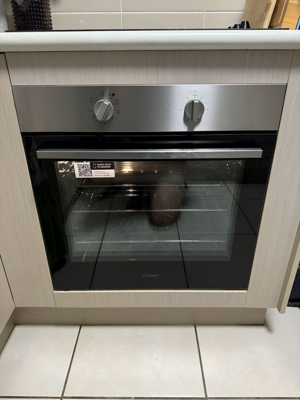 An Avocado is Sitting Inside of a Stainless Steel Oven in a Kitchen — Our Sparky In Urraween, QLD