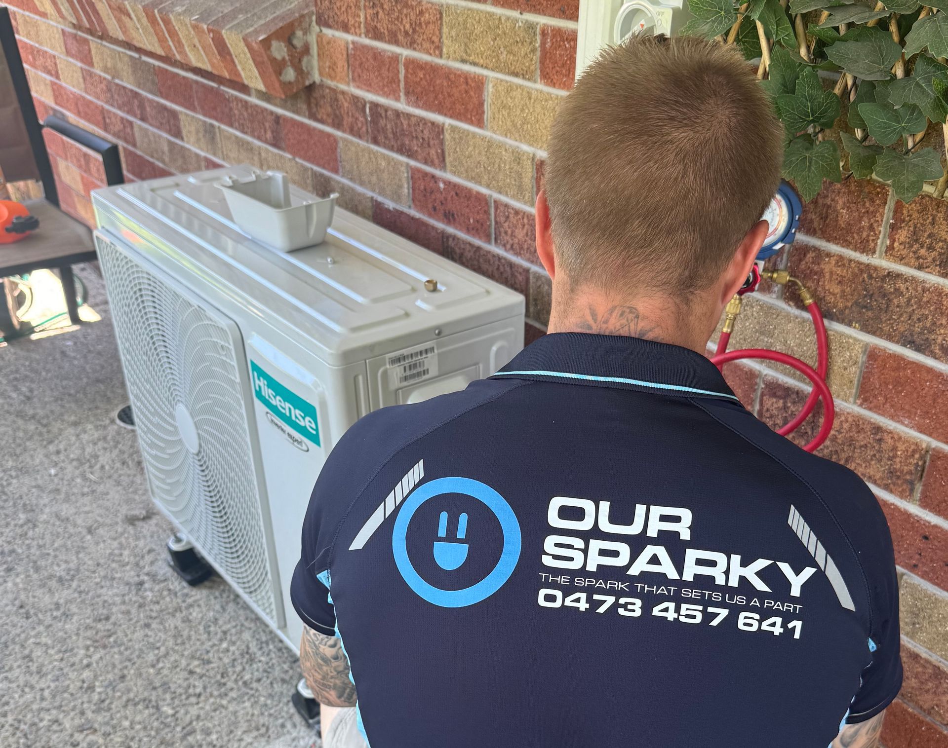 A man is holding a smoke detector in his hand — Our Sparky In Urraween, QLD