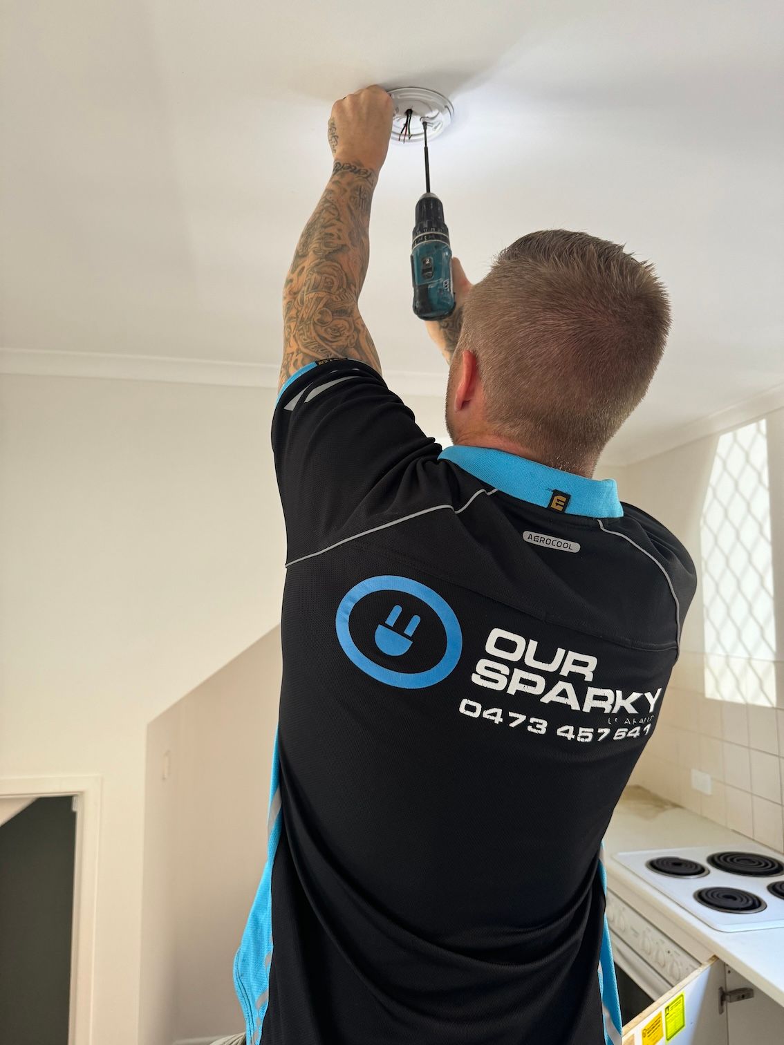 A Man is Working on a Light Installation — Our Sparky In Urraween, QLD