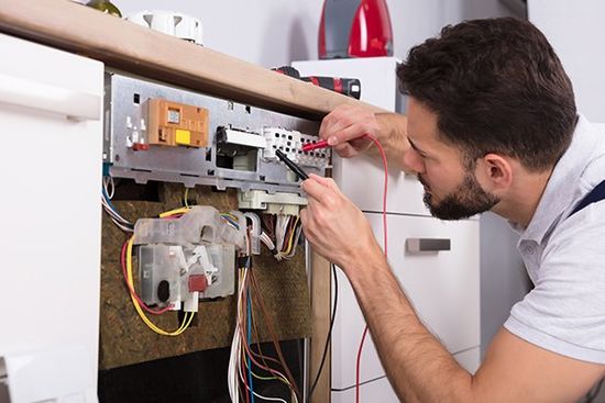Male Technician Examining Dishwasher — Cape Coral, FL — Always Affordable Electric