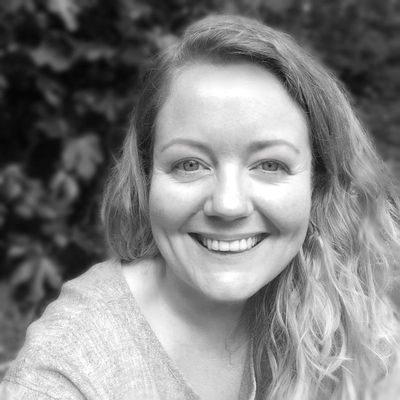 Jemma's light skinned woman with blonde wavy hair, smiles at the camera