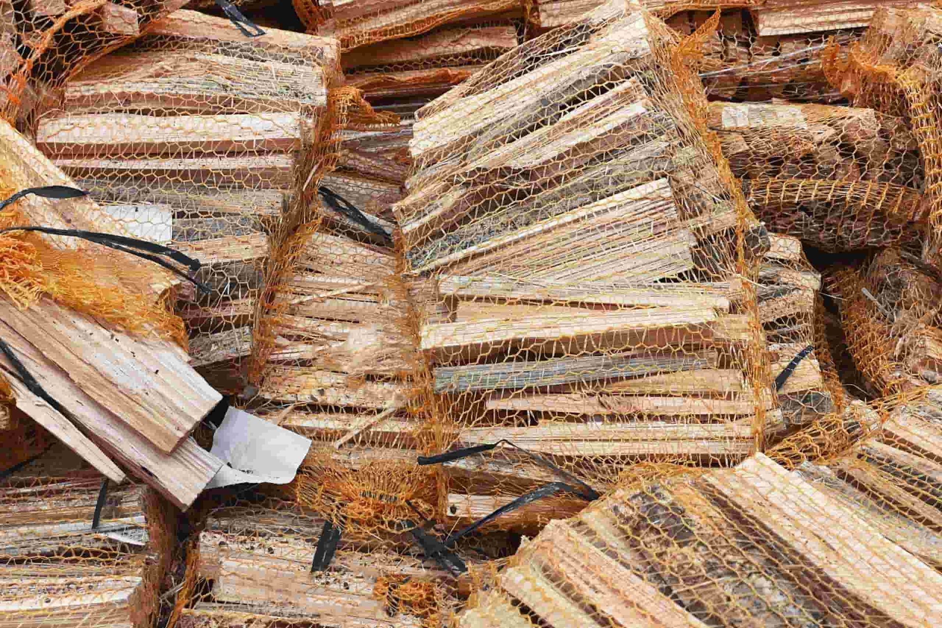A Pile of Wood is Sitting on Top of Each Other on a Table — Grind It Stump Grinding & Tree Removal in Falls Creek, NSW