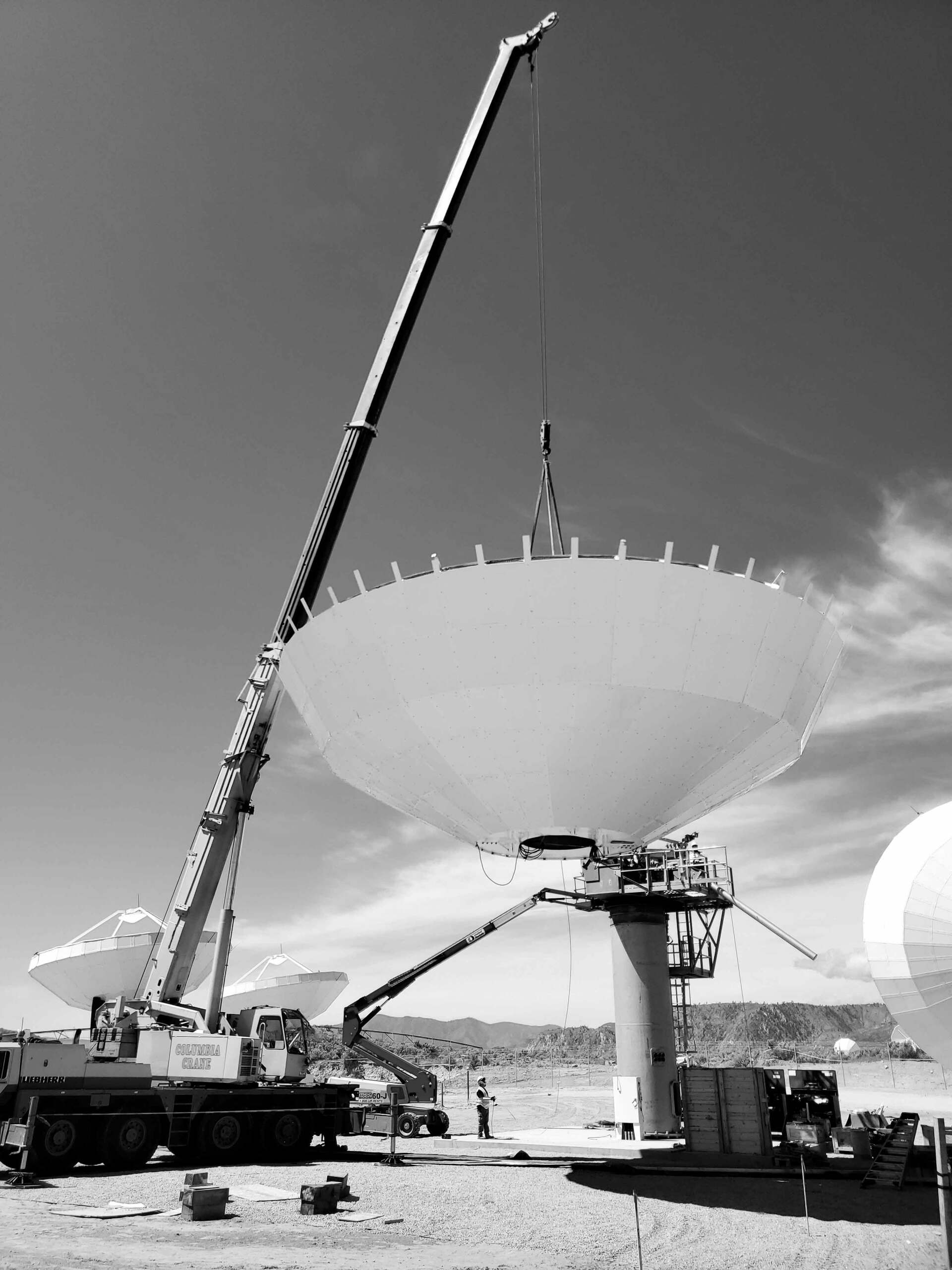 Crane Lifting Satellite Dish in Black and White Effect — Wenatchee, WA — Columbia Cranes