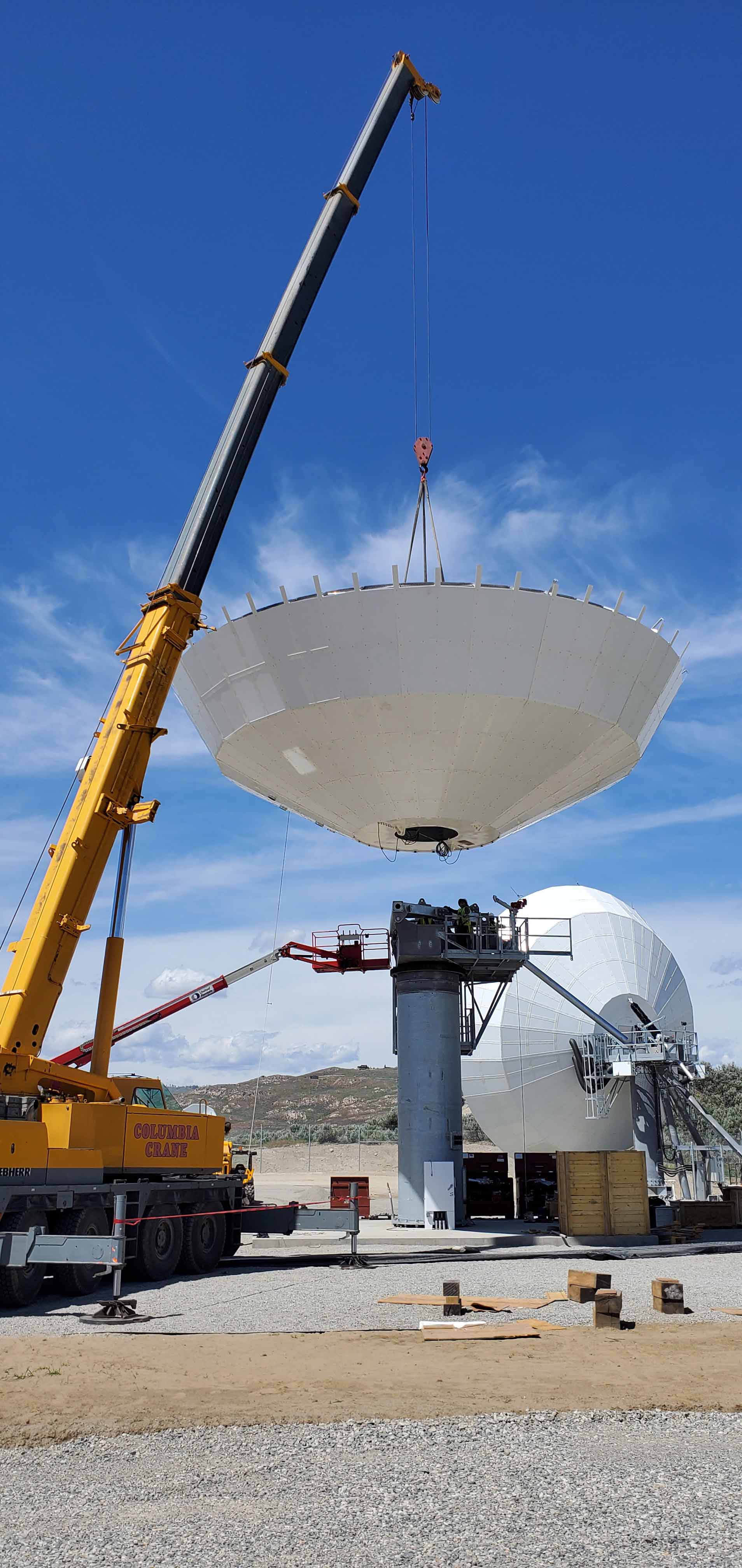 Installing White Satellite Dish — Wenatchee, WA — Columbia Cranes