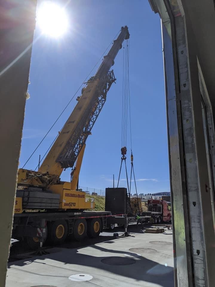 Crane Lifting Yellow Engine into Transport Truck — Wenatchee, WA — Columbia Cranes