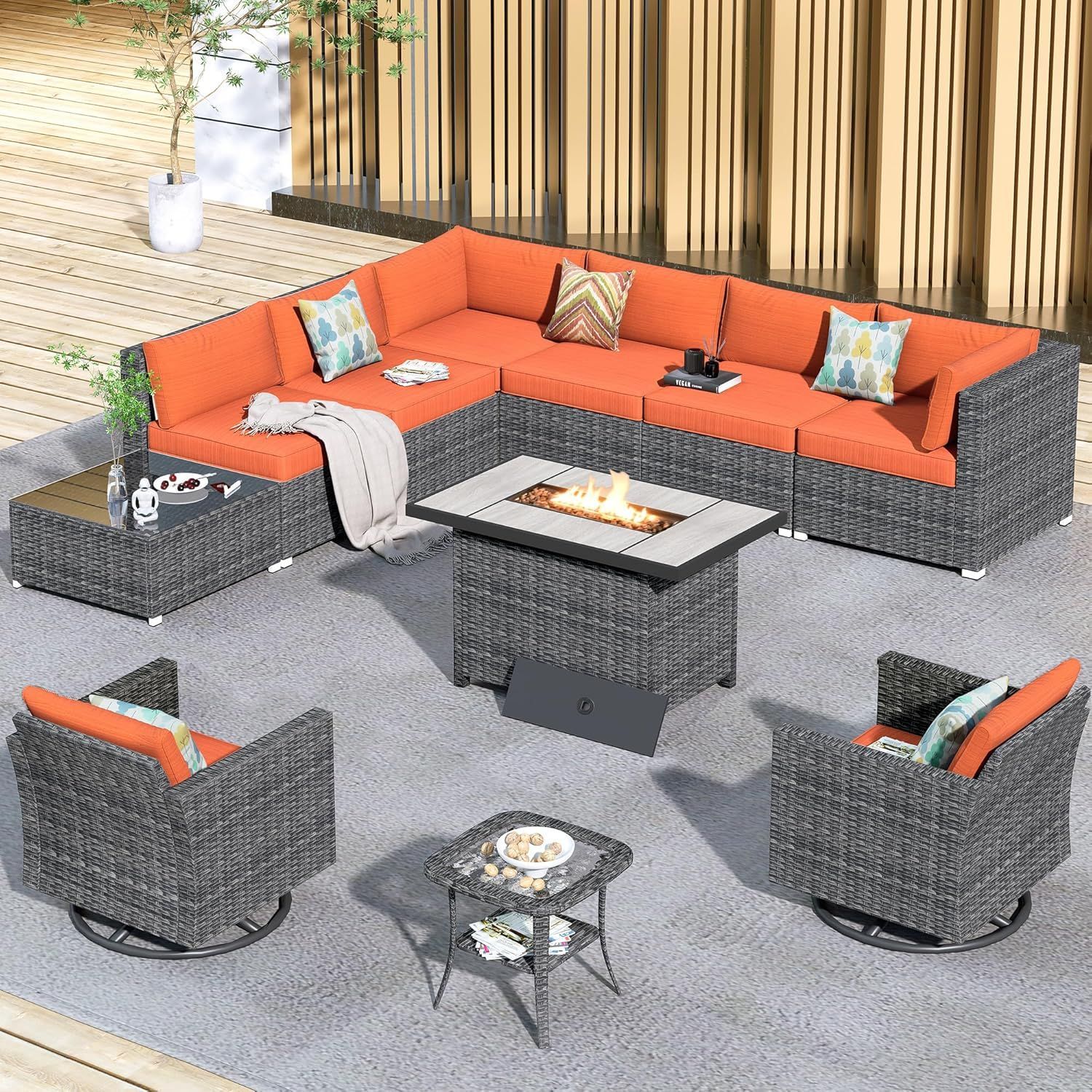 Outdoor patio furniture set with orange cushions and a fire pit on a concrete patio