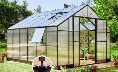 A large, black-framed greenhouse with open doors and windows