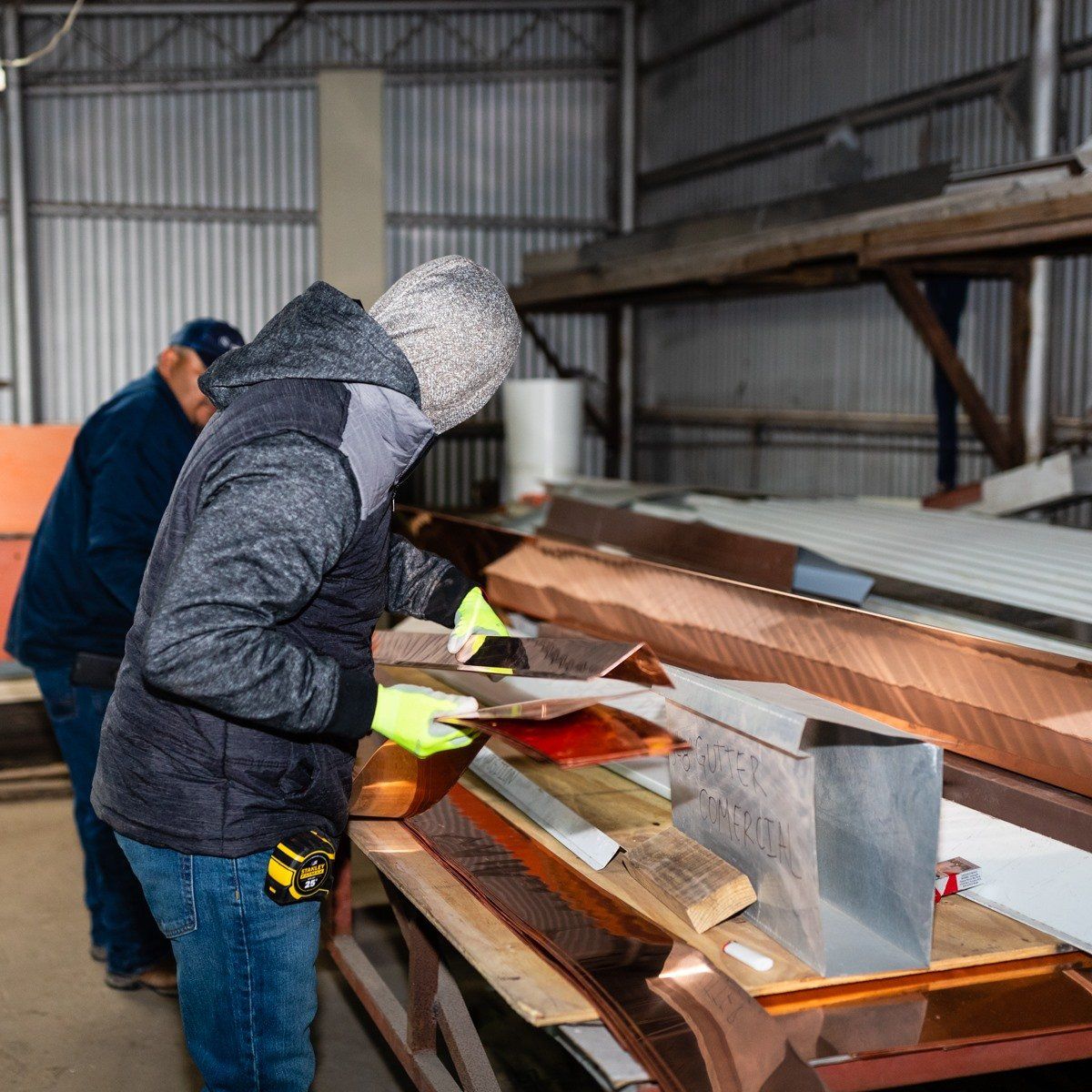 Professional worker looking to a metal — Corpus Christi, TX — Gill Roofing Co Inc