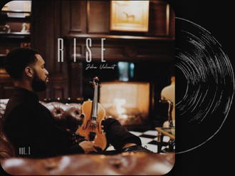 A man sitting on a couch playing a violin next to a record labeled rise