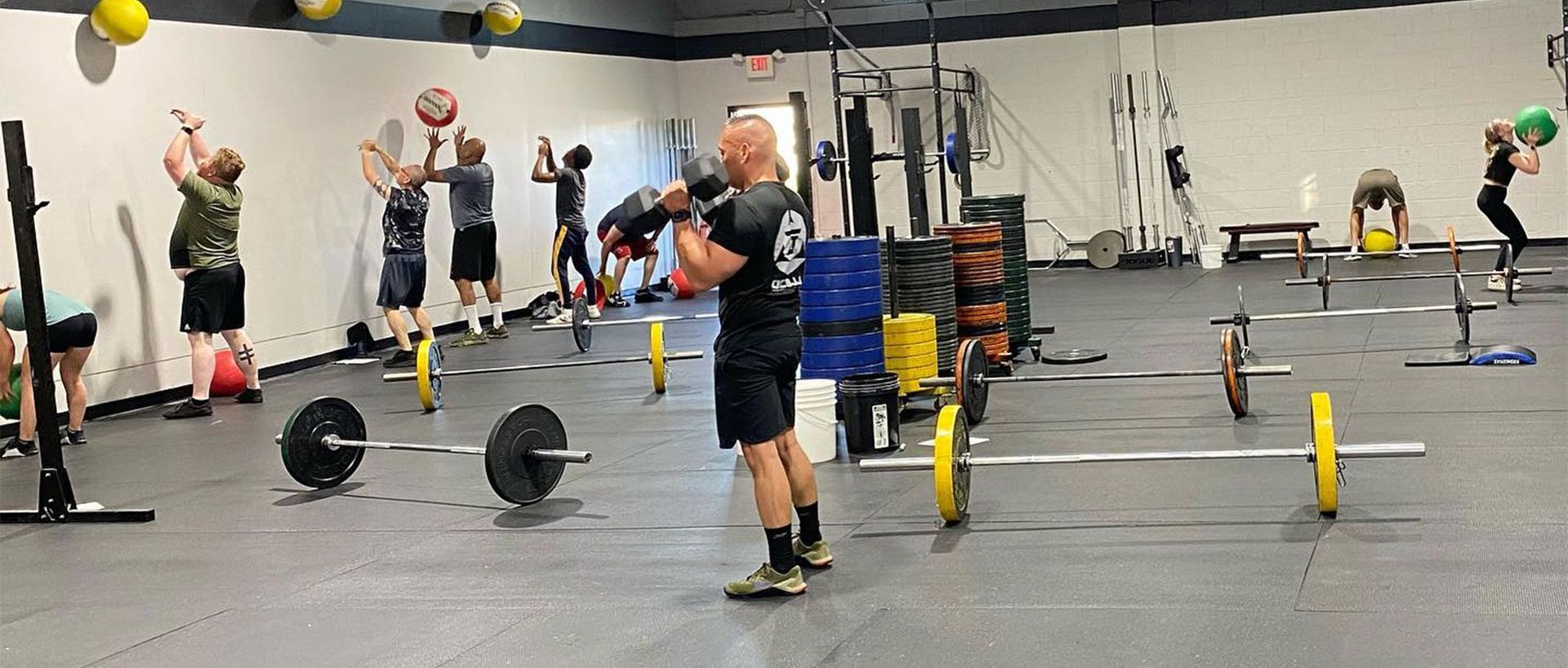A group of people are doing exercises in a gym.