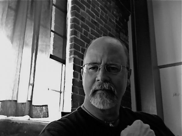 A close up of a woman 's face with a flower in her hair.