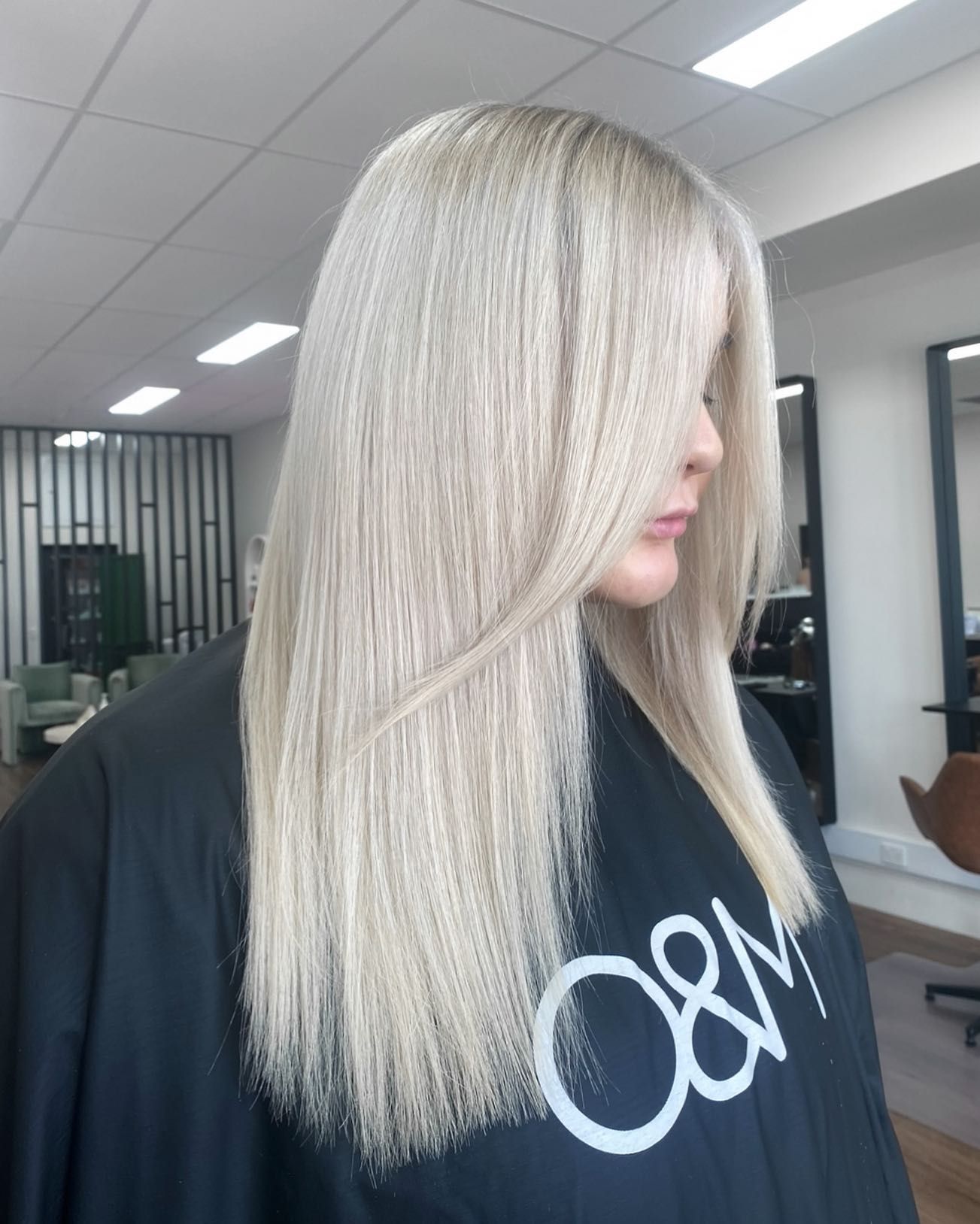 A Woman With Long Blonde Hair Is Sitting In A Chair In A Salon — Mysa on Flinders In Townsville City, QLD