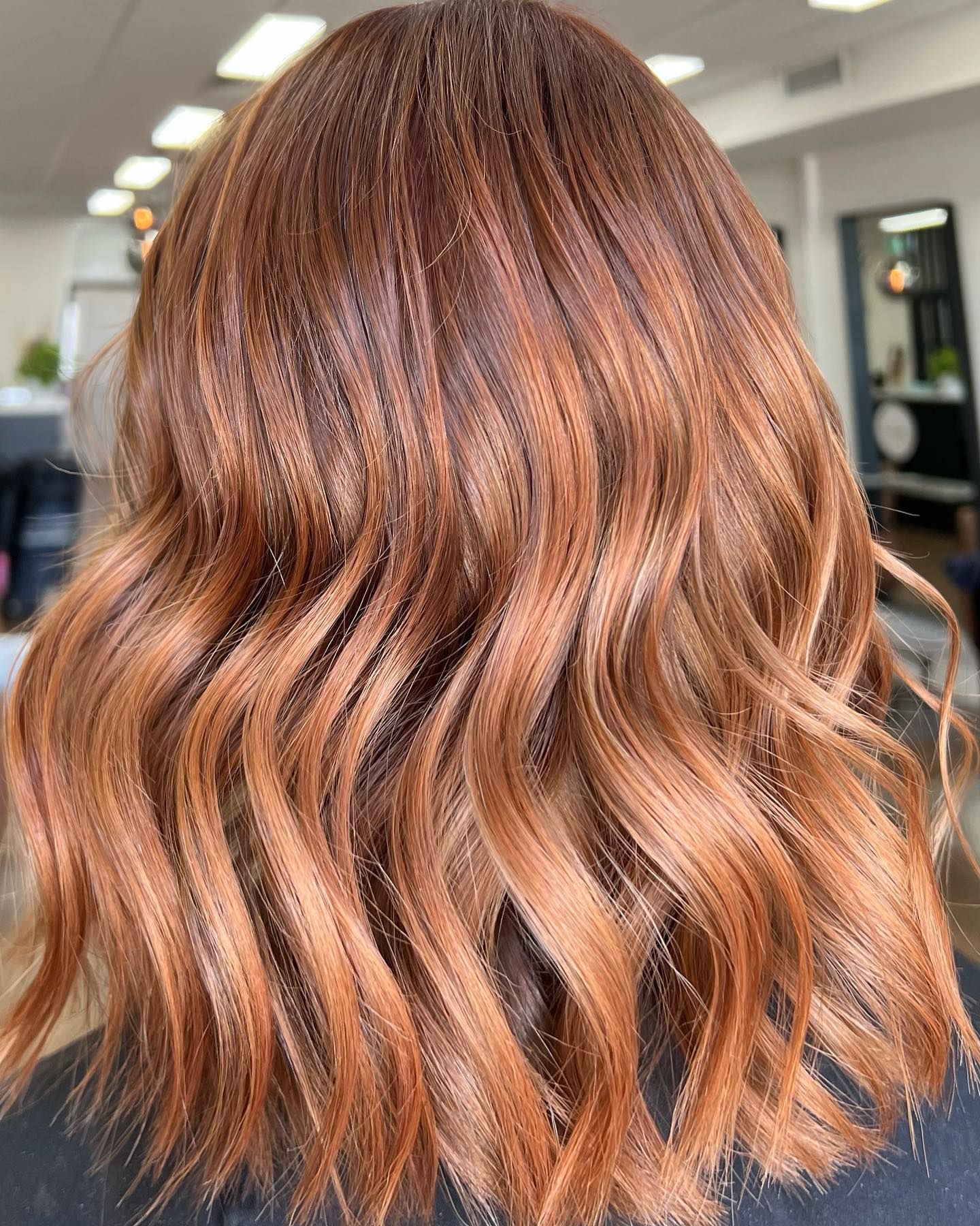 A woman with long red hair is sitting in a salon. — Mysa on Flinders In Townsville City, QLD