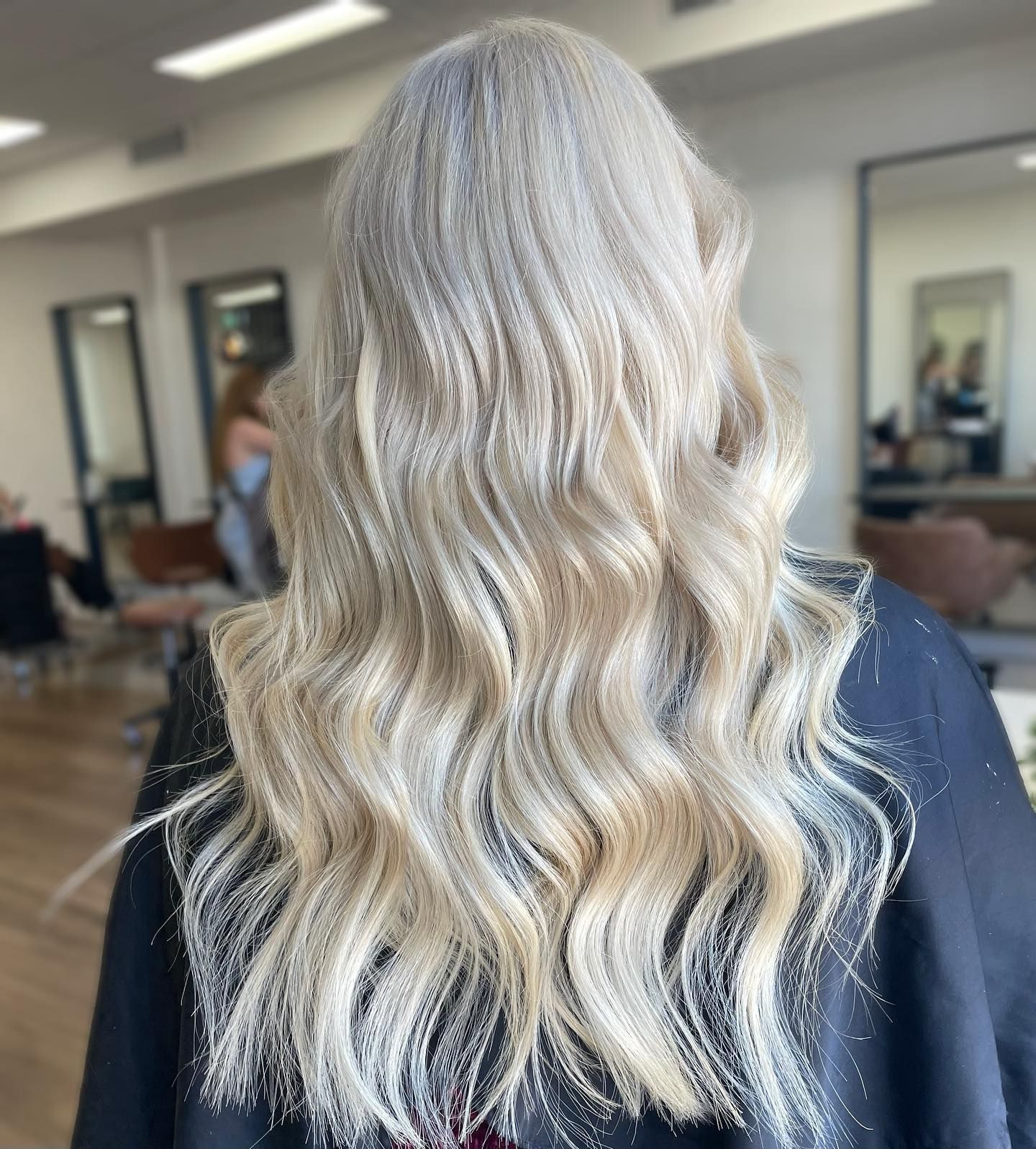 A woman with long blonde hair is getting her hair cut in a salon. — Mysa on Flinders In Townsville City, QLD