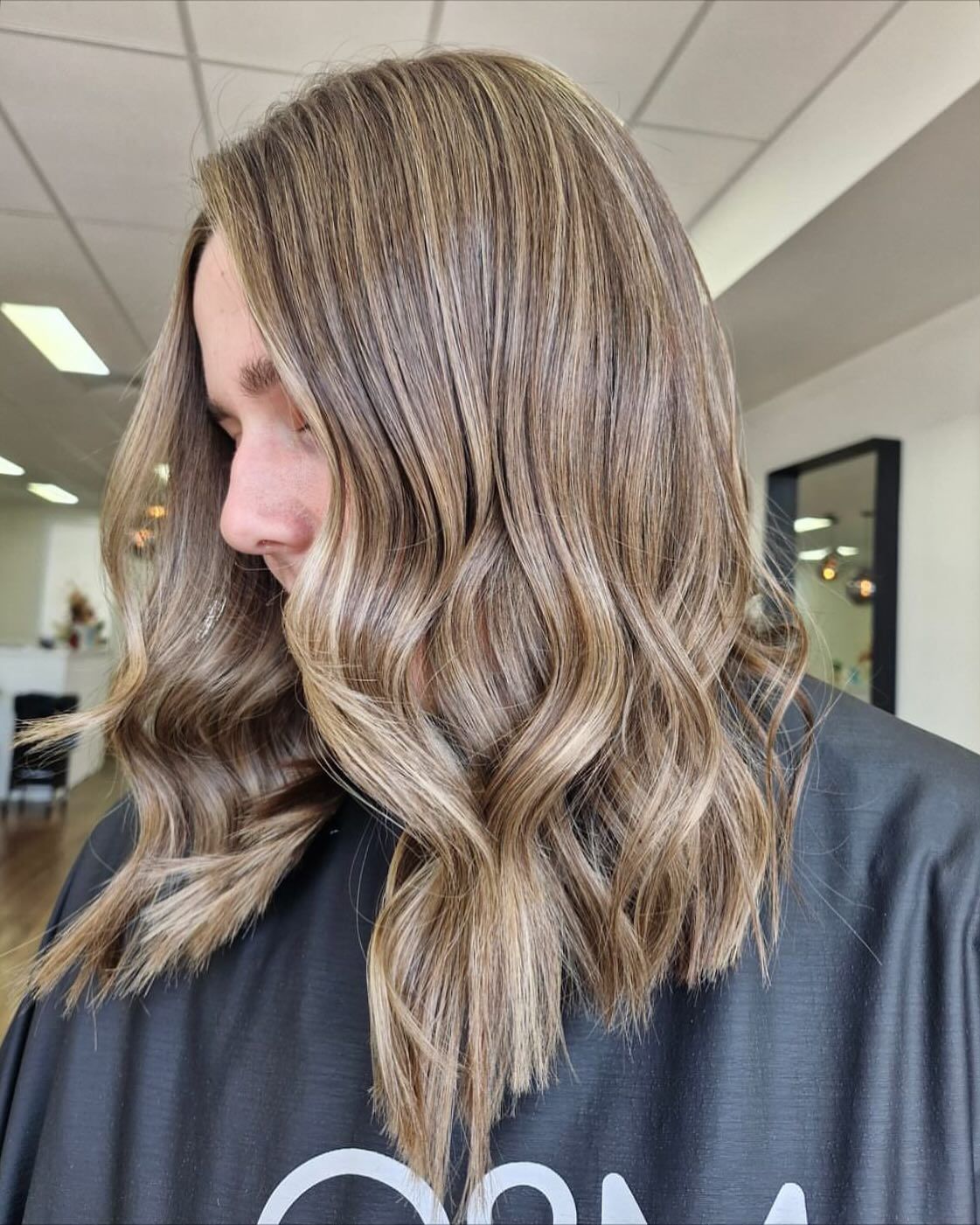 A woman with long brown hair is wearing a black cape. — Mysa on Flinders In Townsville City, QLD