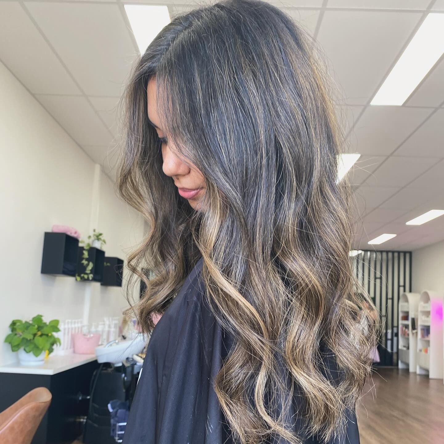 A woman with long hair is standing in a salon. — Mysa on Flinders In Townsville City, QLD